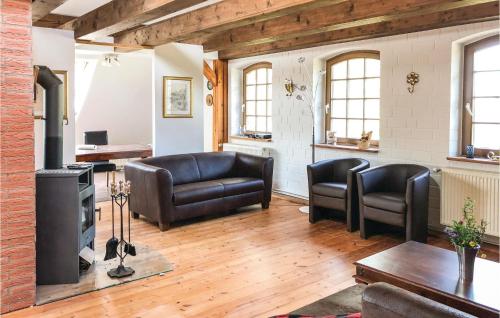 a living room with leather furniture and a fireplace at Landhaus Dragun in Dragun