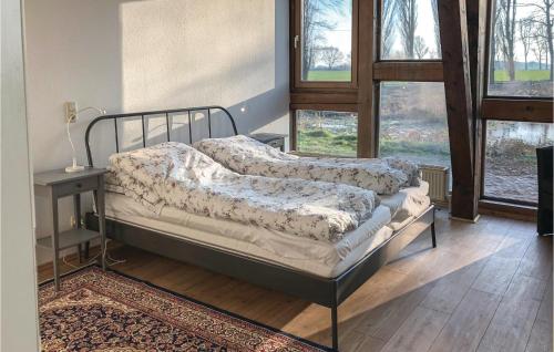 two beds in a room with a table and windows at Landhaus Dragun in Dragun