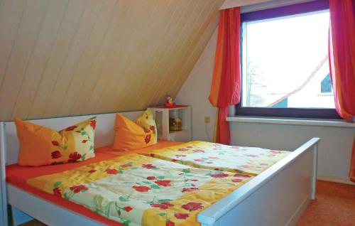 a bed in a room with a window at Stunning Home In Sundhagen Ot Tremt in Falkenhagen