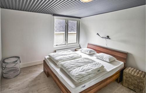 a bedroom with a bed and a window at Berg En Zee 1 in Bergen aan Zee