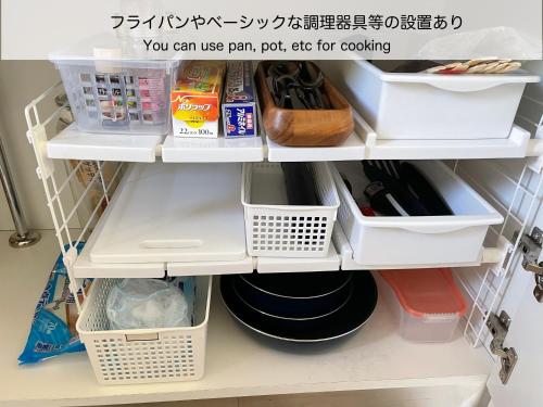 a shelf in a kitchen with some food items at BATONWORKS Naoshima in Naoshima
