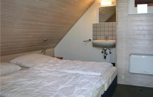 a bedroom with a bed and a sink in a room at Ferienhaus 102 In Kirchheim in Kemmerode