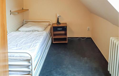 a small bedroom with a bed and a night stand at Amazing Home In Brüssow With Wifi in Brüssow