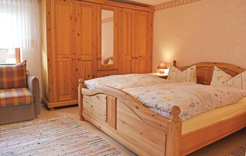 a bedroom with a wooden bed and a chair at Lovely Apartment In Winterberg-altenfeld With Wifi in Winterberg