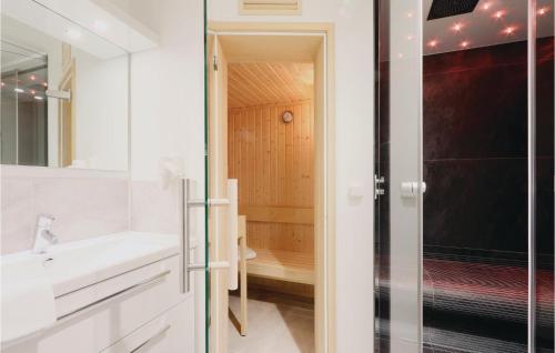 a bathroom with a sink and a shower at Stunning Apartment In Lbeck Travemnde With 2 Bedrooms, Sauna And Wifi in Travemünde