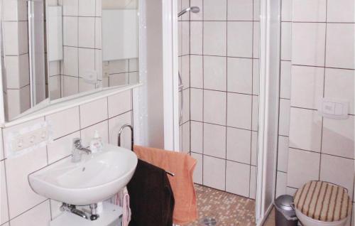 a white bathroom with a sink and a shower at 1 Bedroom Amazing Apartment In Settin in Settin