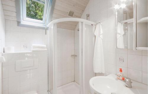 a white bathroom with a shower and a sink at Ferienhaus 28 In Kirchheim in Reimboldshausen