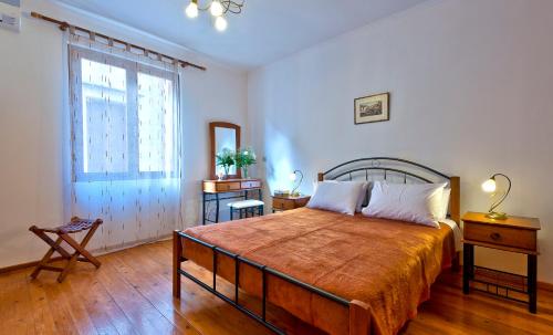 a bedroom with a large bed and a window at Aphrodite House in Chania