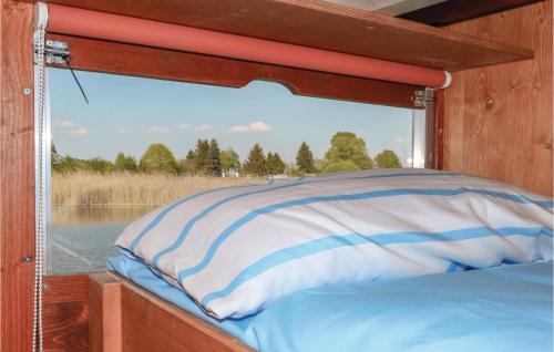 a window on the back of a boat with a pillow at 2 Bedroom Awesome Ship In Neustrelitz in Buchholz