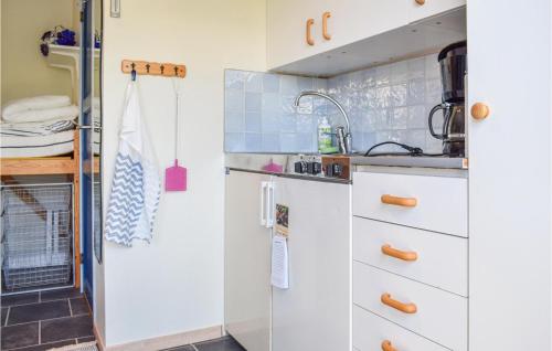 a kitchen with white cabinets and a sink at Sandvik 2 in Löttorp