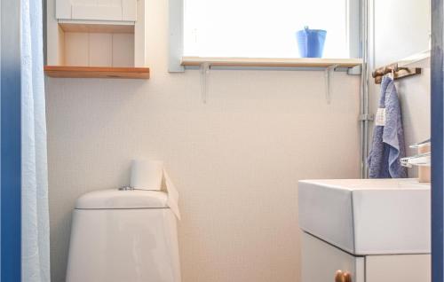 a small bathroom with a toilet and a sink at Sandvik 2 in Löttorp