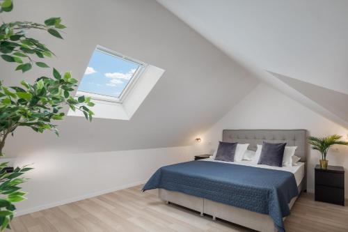 a white bedroom with a bed and a window at Villa Mirta in Bol