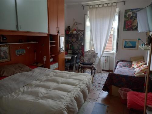 a bedroom with a bed and a couch and a window at Piazza Bologna via Stamira 74 interno 12 Vita Felice in Rome