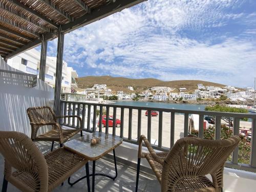 a balcony with chairs and a table and a view at Xenios Zeus Apartments in Astypalaia