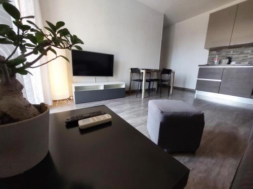 uma sala de estar com um sofá e uma mesa com uma planta em Casa Laura em Ventimiglia