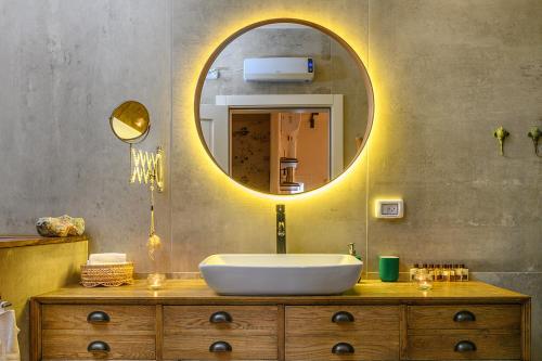 a bathroom with a sink and a mirror at אצל רנאטה in Abirim