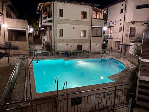 a large swimming pool in front of a building at night at Alojamiento Los Tejos - Arroyo Frío in Arroyo Frio