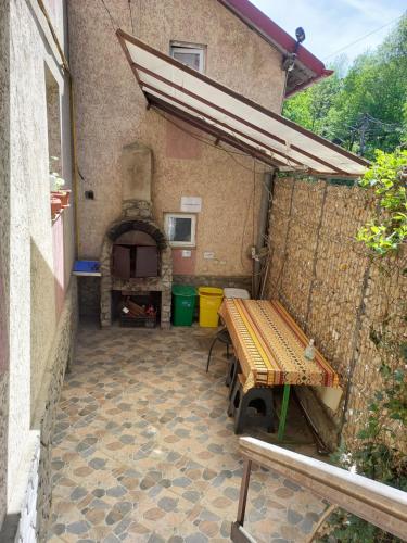 an outdoor patio with a bench and a pizza oven at CASA RYANA SINAIA in Sinaia