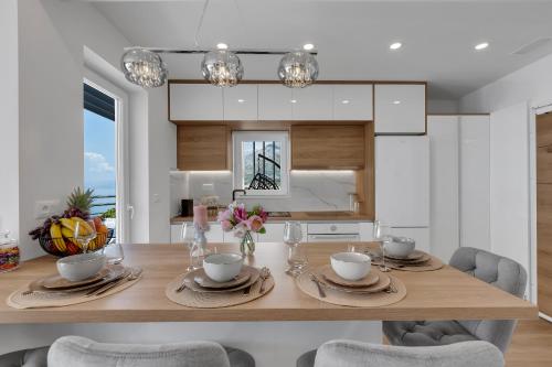 a dining room with a wooden table with chairs at Luxury Penthouse - Big Blue in Tučepi