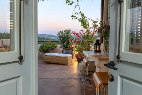 a door leading to a patio with a table and chairs at אצל רנאטה in Abirim