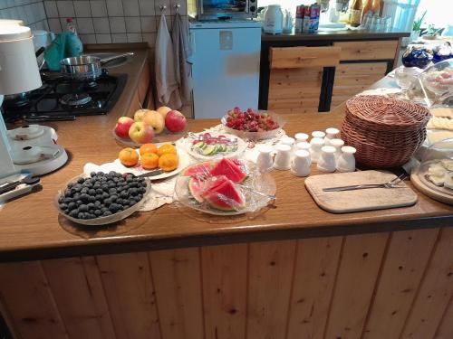 a kitchen counter with fruits and other foods on it at Pension Edelweiß in Kurort Gohrisch