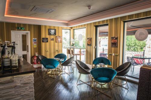 a bar with chairs and a table in a room at The Old Hall Hotel in Coventry