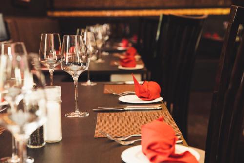 a table with wine glasses and red napkins at The Old Hall Hotel in Coventry