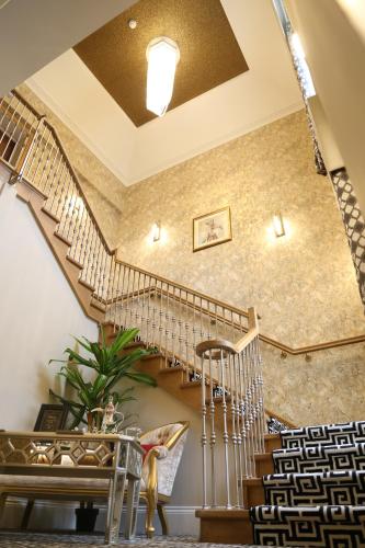 a spiral staircase in a building with a stair case at The Old Hall Hotel in Coventry