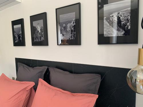 a living room with a couch and pictures on the wall at Le 7 in Vieille-Toulouse