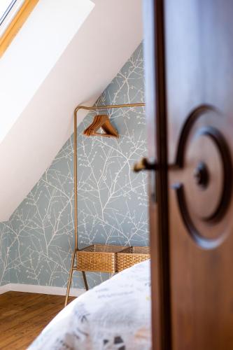 a bedroom with a bed and a blue wall at Superbe maison avec piscine et jacuzzi dans les dunes in Ambleteuse