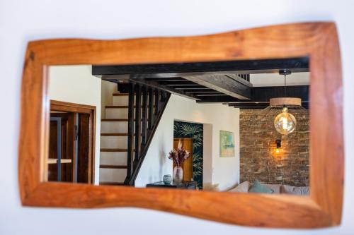 a mirror with a reflection of a living room at Superbe maison avec piscine et jacuzzi dans les dunes in Ambleteuse