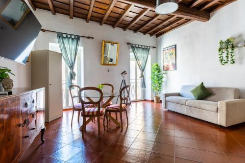 a living room with a table and chairs and a couch at Navona Open Space Apartments in Rome