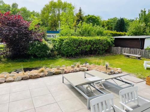 a patio with a table and chairs in a yard at Seependance in Grömitz