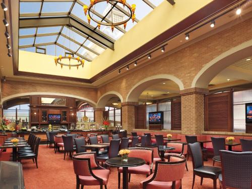 a restaurant with tables and chairs in a lobby at Ameristar Casino Hotel Council Bluffs in Council Bluffs