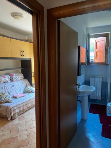 a bedroom with a bed and a sink at Aria Fresca in Sovere