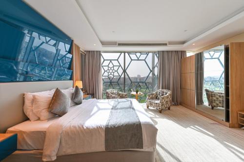 A bed or beds in a room at Al Mansour Suites Hotel