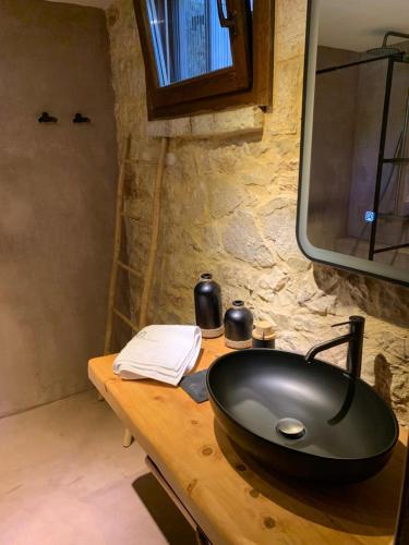 a bathroom with a black sink on a wooden table at Villa Danae in Meganisi