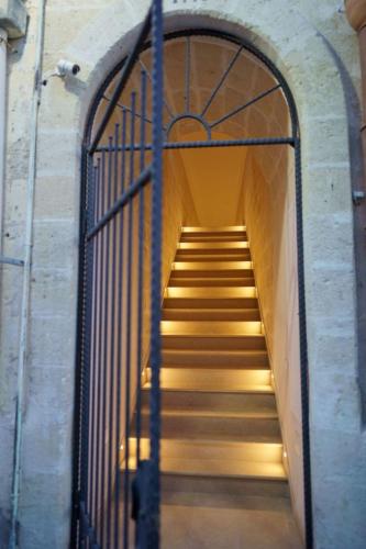 a stairway with a metal gate and stairs with lights at I Lamioni - Suite & accommodation in Matera