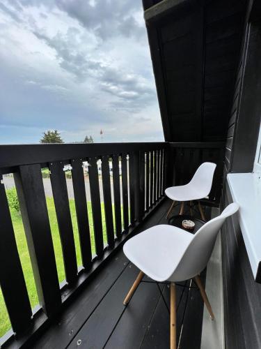 a balcony with two chairs and a view of the ocean at Aparts4ring Nürburg in Nürburg