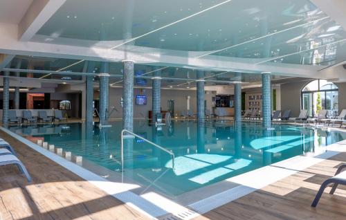 a large swimming pool in a building at Casa di Fiore SPA and Medical Hotel, Mineral Pools & Private Beach in Kranevo