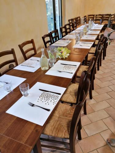 a long table with white napkins and glasses on it at Fattoria di Rigone in Coltavolino