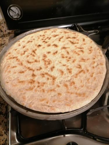 a pizza pan sitting on top of a stove at Fattoria di Rigone in Coltavolino