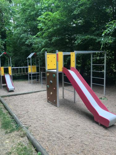 a playground with a slide in a park at L'étape de la Tour in Grand-Fougeray