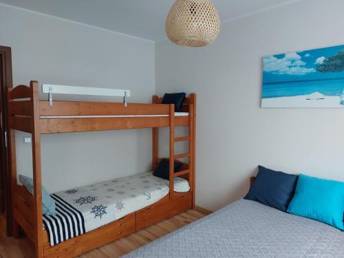 a bedroom with two bunk beds and a bed at 9 APARTAMENT VILLA NORD - parking in Jastrzębia Góra