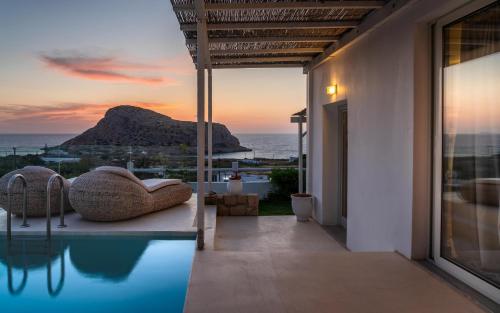 a house with a pool with a view of the ocean at Arkasa Palace in Arkasa