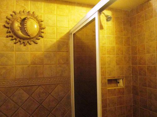 a bathroom with a shower with a mirror on the wall at Hotel Real Azteca in Mexico City