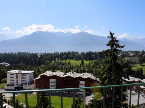 a view from the balcony of a resort with mountains at Hôtel Splendide in Crans-Montana
