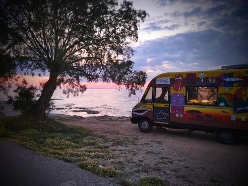 a food truck parked next to a tree on the beach at Casa Di Penny 2 in Kyparissia