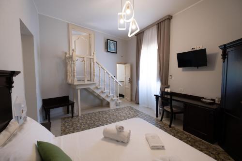 a hotel room with a bed and a staircase at Hotel Borgo di Ciàula in Santa Flavia