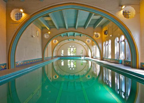 a swimming pool in a building with an archway at Berkeley City Club Hotel in Berkeley